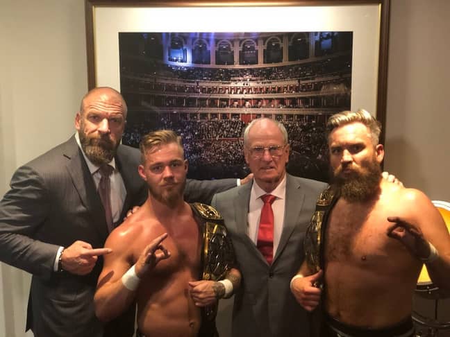 Trent Seven (Far R) and tag team partner Tyler Bate (L) with Triple H and Johnny Saint. (Image Credit: Triple H/Twitter)
