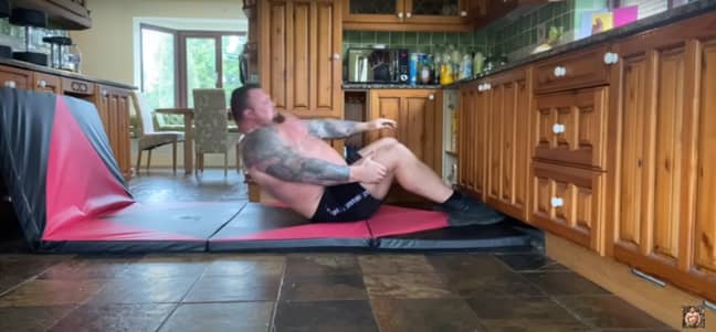 Hall comments on the sit-ups being 'really, really hard'. (Image Credit: Eddie Hall/YouTube)
