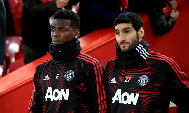 Fellaini on the bench with Paul Pogba in Jose Mourinho's last game in charge. Image: PA Images
