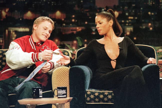 Ross Rebagliati shows his medal to supermodel Veronica Webb on a TV show. Credit: Alamy