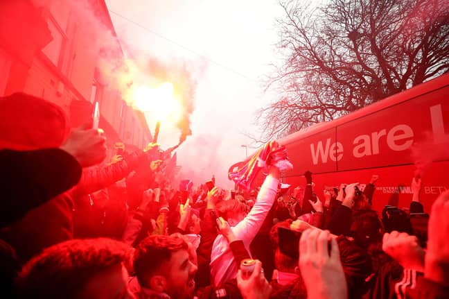 Liverpool fans let off flares. Image: PA
