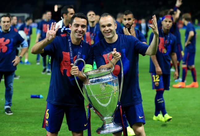 PA: Xavi celebrates winning his fourth Champions League title alongside Andres Iniesta.