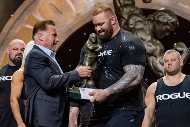 Bjornsson, also a former World's Strongest Man winner, getting a trophy from Arnold Schwarzenegger. Image: PA Images 