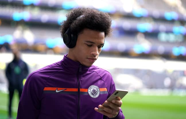 Sane checking his phone for transfer updates. Image: PA Images