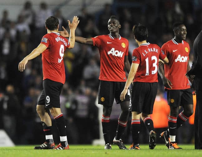 Pogba high fives his teammate after making his first team debut. Image: PA Images