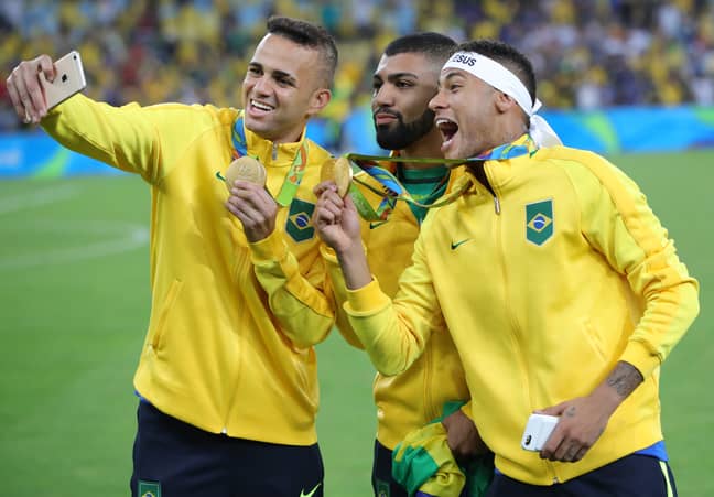 Neymar (R), Gabriel Barbosa and Luan of Brazil take a selfie after the medal ceremony of the Men's soccer Gold Medal Match between Brazil and Germany during the Rio 2016 Olympic Games