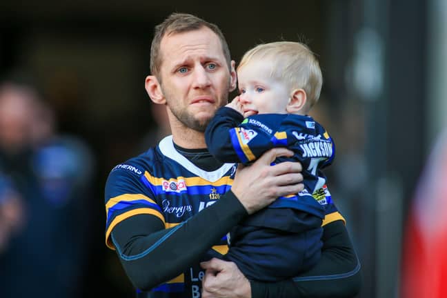 Rob Burrow with his young son. Credit: Alamy