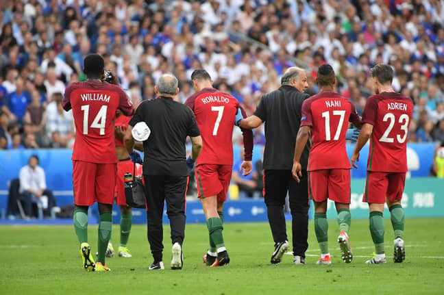 Ronaldo limps off the pitch aided by the medical team. Image: PA