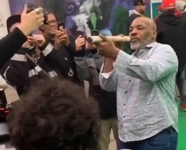 Mike Tyson smoked the huge joint while people took his picture. Credit: Instagram/cmw420tv