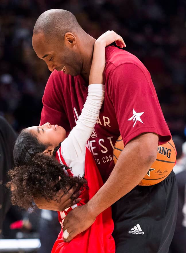 Kobe Bryant hugs his daughter Gianna on the court. Credit: PA