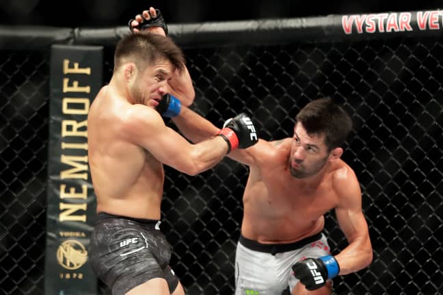 Henry Cejudo, left, takes a firm shot from challenger Dominick Cruz, right, on Saturday night. (Image Credit: PA)