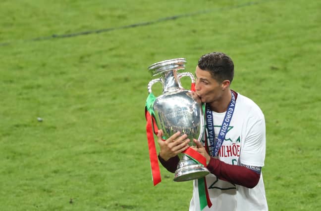 Ronaldo plants a kiss on the trophy. Image: PA