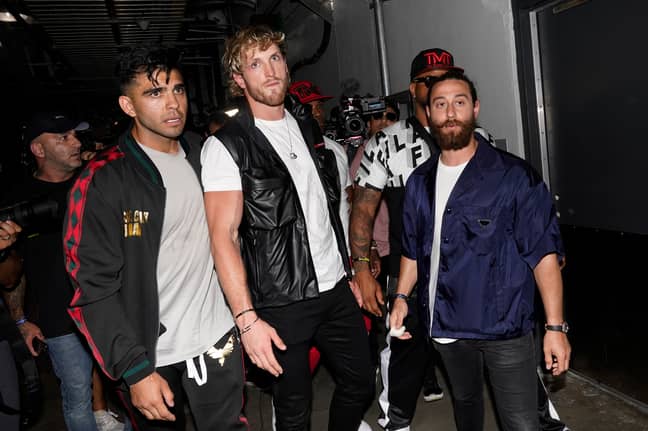 Logan Paul is held back by his team after Mayweather and Jake Paul's (not pictured) brawl. (Image Credit: PA)