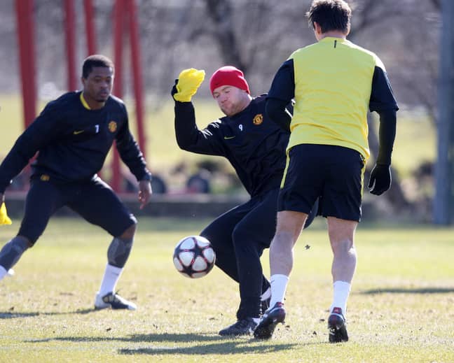 PA: Patrice Evra in a training session with Gary Neville and Wayne Rooney.