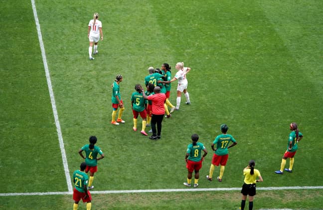 Cameroon fans argue with the referee. Image: PA Images