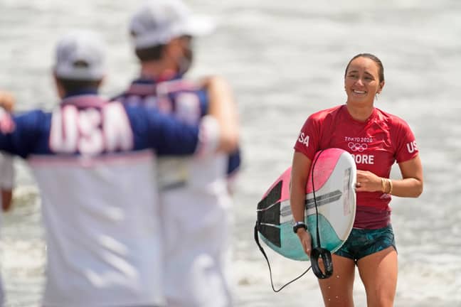 Carissa Moore, of the United States, smiles after wining her heat during third round of women's surfing competition (Credit: PA)